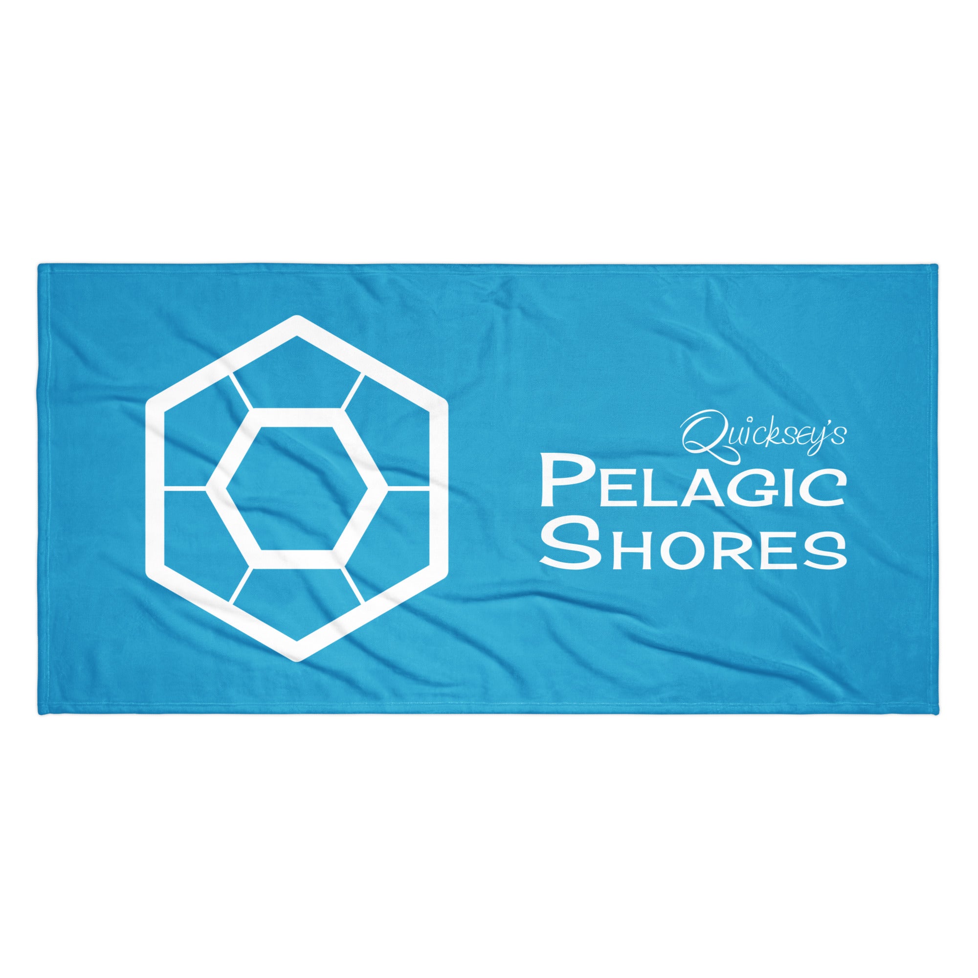 Blue beach towel with white Pelagic Shores logo.