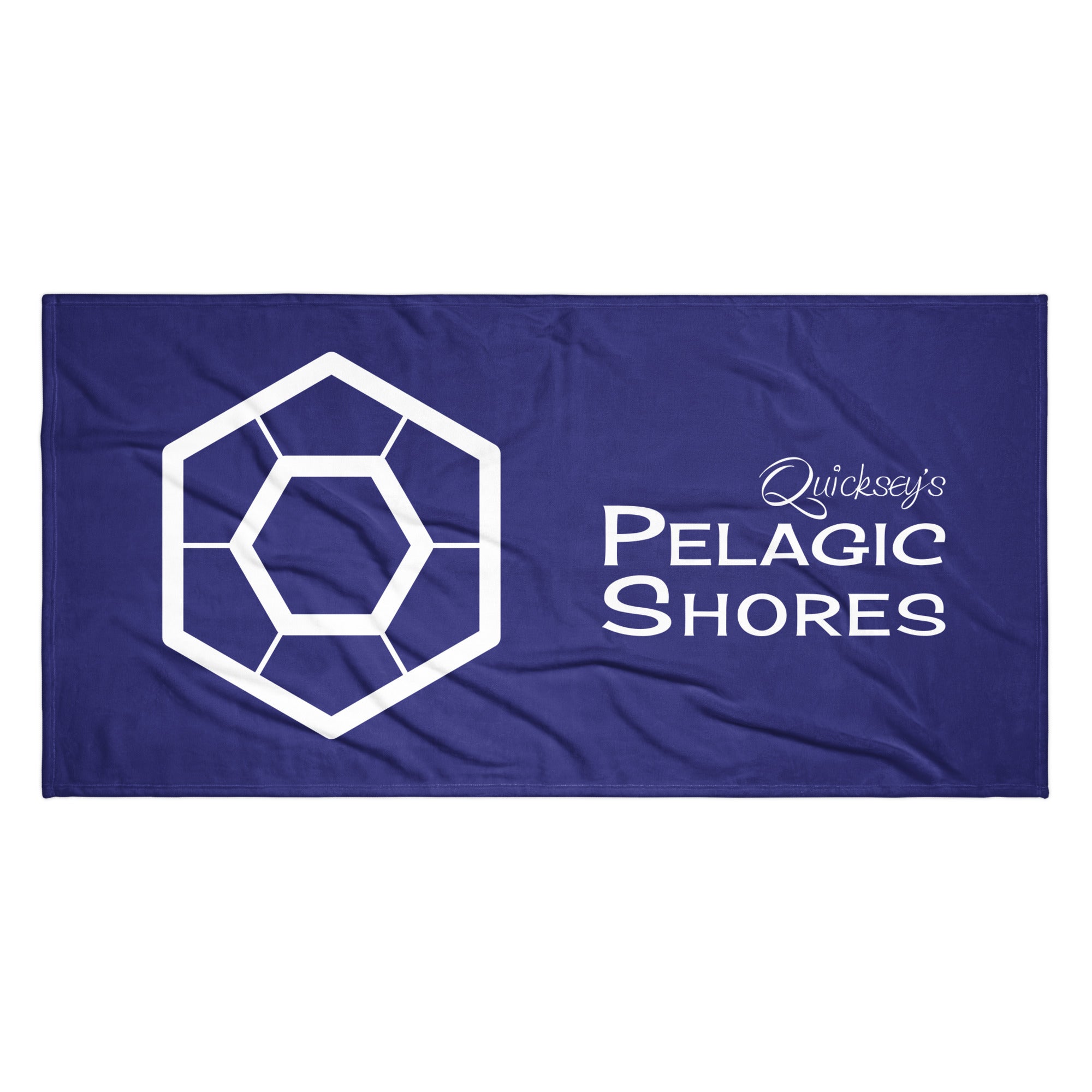 Dark blue beach towel with white Pelagic Shores logo.
