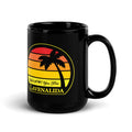 Glossy black mug with stylized sunset design with silhouette palm tree and the phrase ‘We’l @?#! you first’ above the word ‘Lavenalida’.