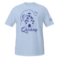 Light blue T-shirt depicting Coral Castle with the Quicksey logo beneath it. A small fairy-like creature is hovering and yelling and a line depicts the fairy’s flight path: crashing into the castle, spiraling, and flying over it.