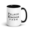 White ceramic mug with black inside and black handle and a black Pelagic Kingdom Park logo on the outside.