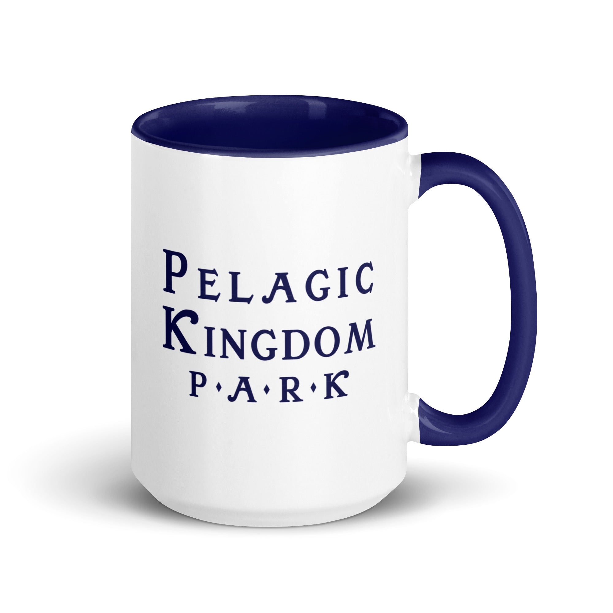 White ceramic mug with dark blue inside and dark blue handle and a dark blue Pelagic Kingdom Park logo on the outside.