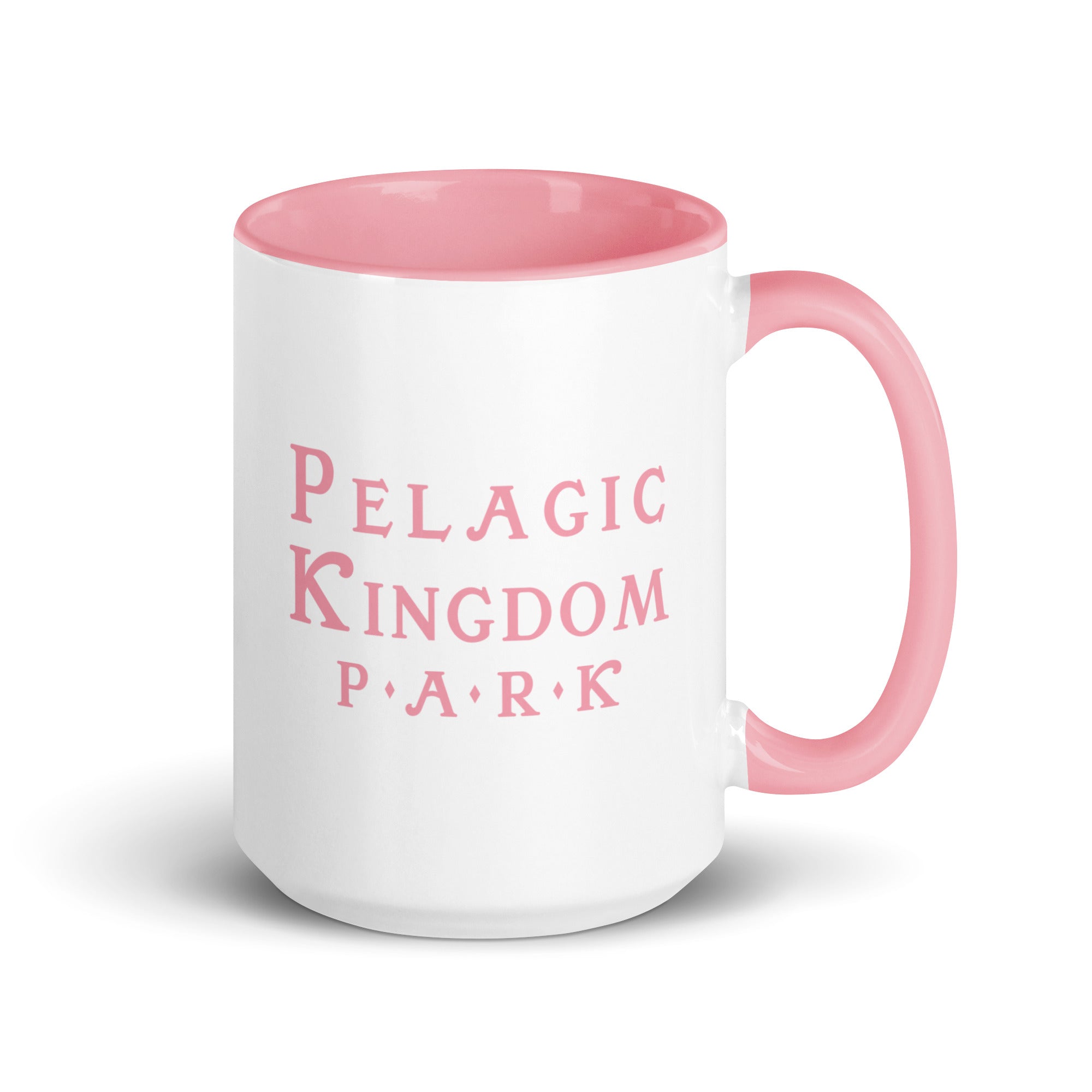 White ceramic mug with pink inside and pink handle and a pink Pelagic Kingdom Park logo on the outside.